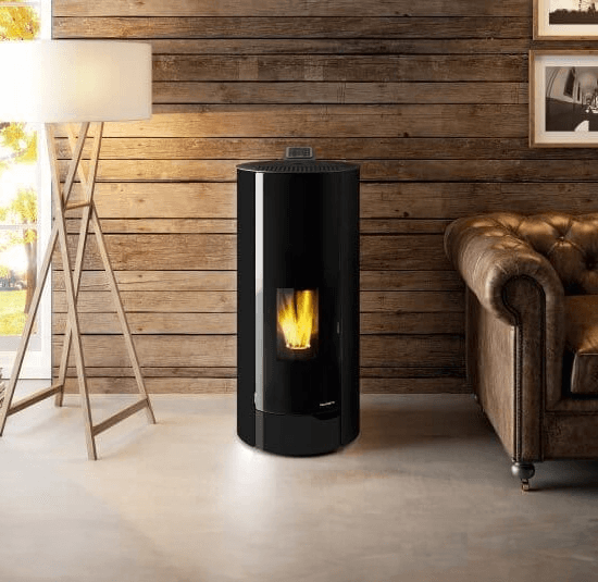 Black Nina Palazzetti pellet heater in front of a wood wall